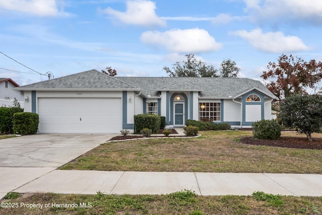 ranch-style house featuring a front yard and a garage