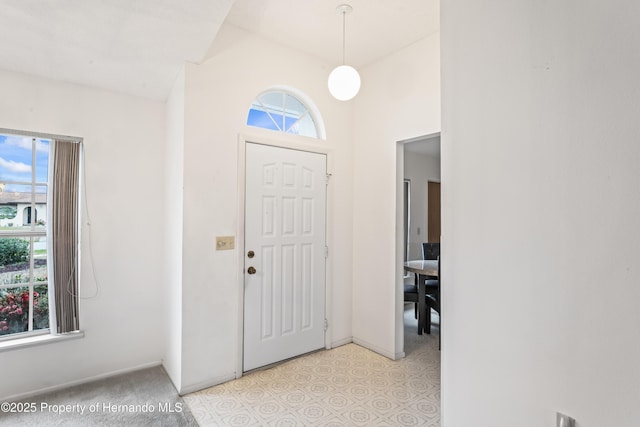 entryway featuring lofted ceiling