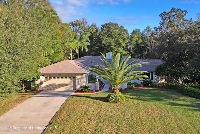 view of front of property featuring a front lawn and a garage