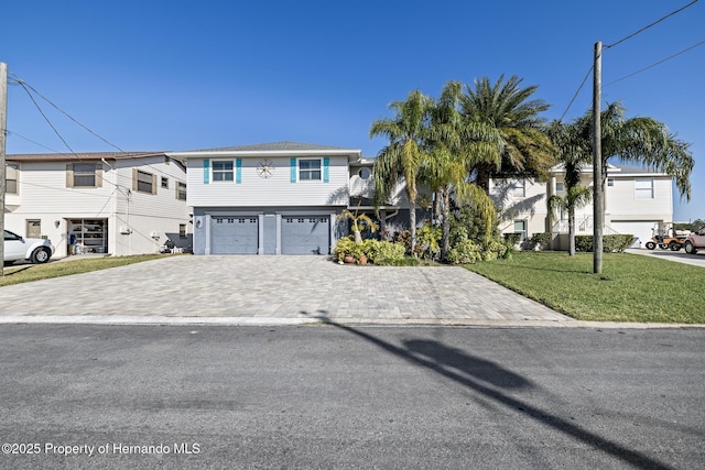 view of front facade featuring a garage and a front lawn