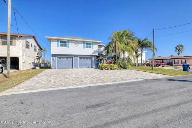 view of front of property with a garage and a front yard