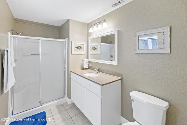 bathroom with toilet, a shower with shower door, tile patterned floors, and vanity