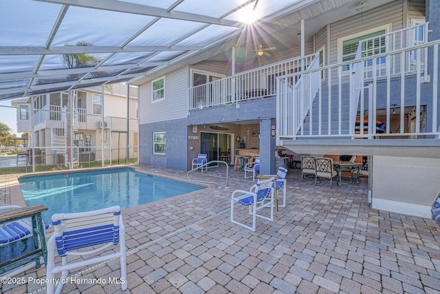 view of pool with a lanai, a bar, and a patio