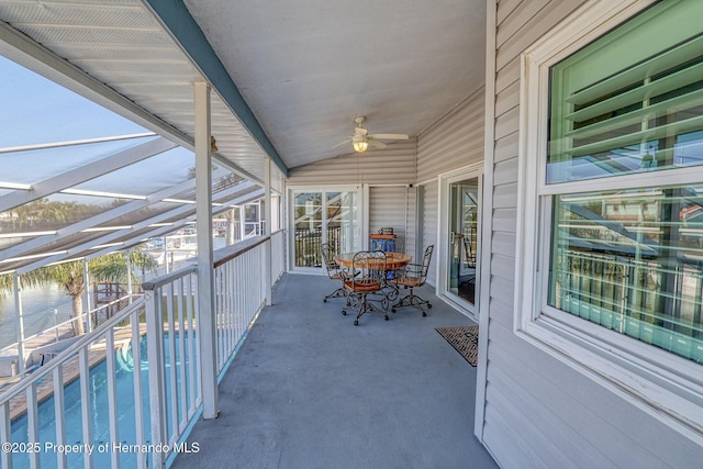 unfurnished sunroom featuring vaulted ceiling and ceiling fan