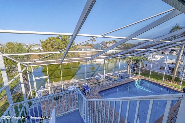 view of pool featuring a lanai, a water view, and a patio