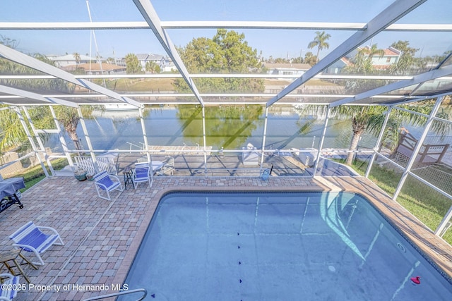 view of pool featuring a lanai, a water view, and a patio