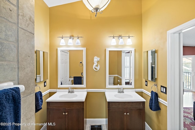 bathroom featuring toilet and vanity