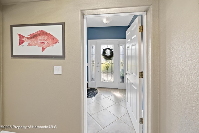 doorway to outside featuring light tile patterned floors