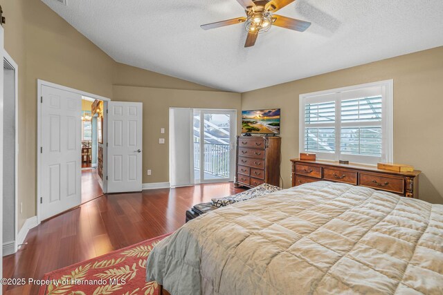 bedroom featuring hardwood / wood-style floors, a textured ceiling, lofted ceiling, access to exterior, and ceiling fan