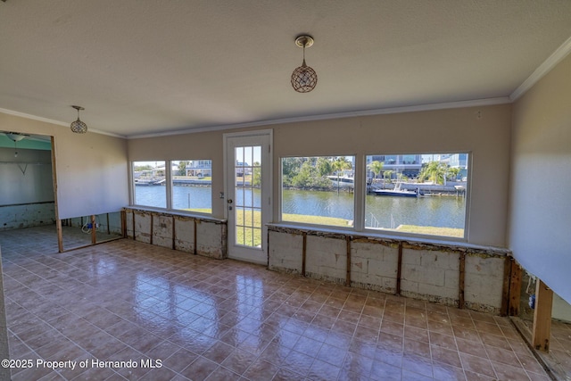 empty room with crown molding and a water view