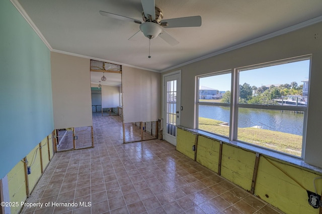 spare room with ceiling fan, a water view, and crown molding