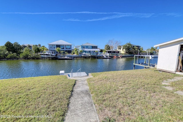 dock area with a water view and a lawn