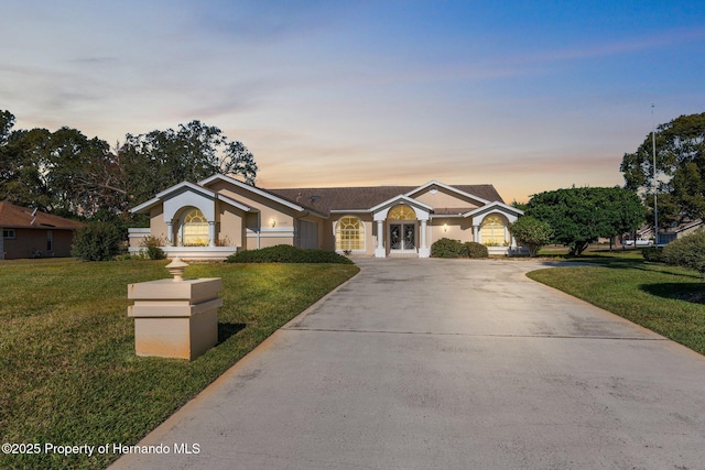 ranch-style home featuring a yard