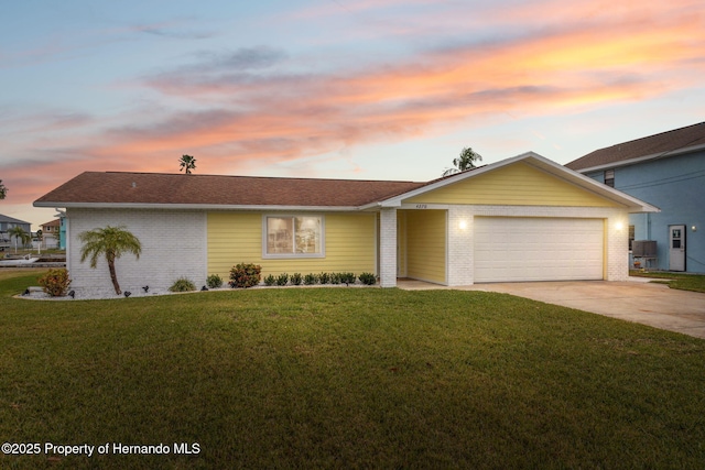 single story home with a yard and a garage