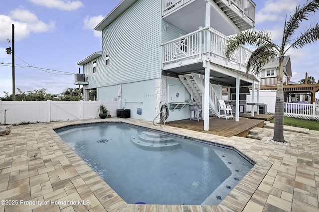 view of swimming pool with a patio area and a deck