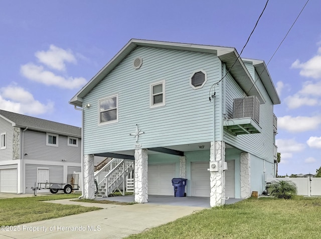 exterior space featuring a front yard, a garage, and a balcony