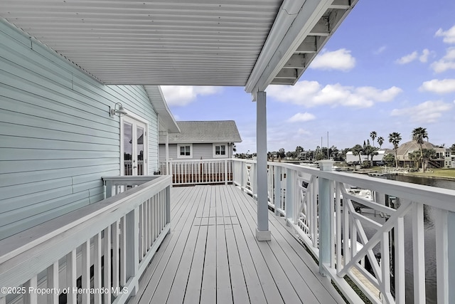 wooden terrace featuring a water view