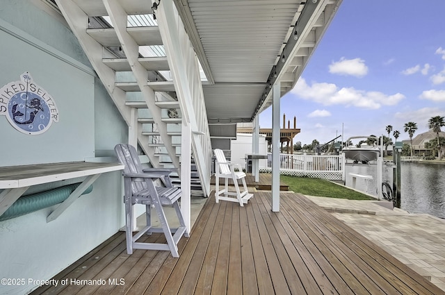 wooden terrace featuring a dock and a water view