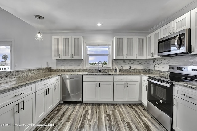 kitchen with appliances with stainless steel finishes, white cabinetry, and sink