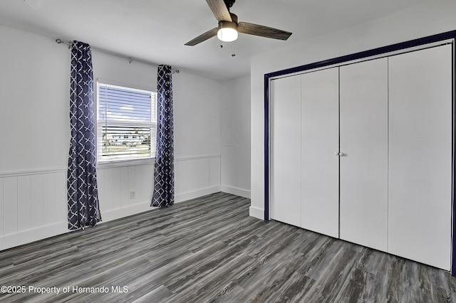 unfurnished bedroom with a closet, ceiling fan, and dark hardwood / wood-style floors