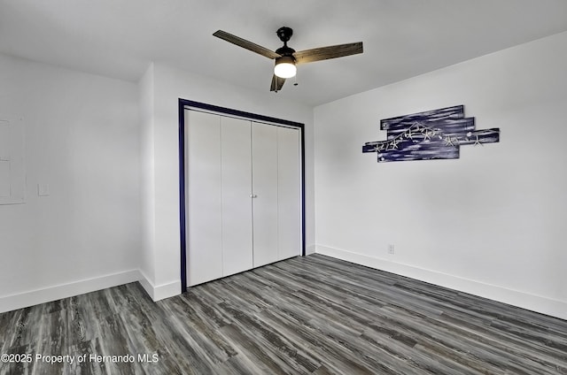 unfurnished bedroom with a closet, ceiling fan, and dark hardwood / wood-style floors