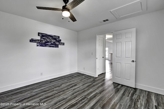 spare room featuring ceiling fan and dark wood-type flooring