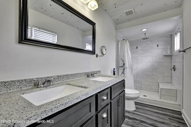 bathroom featuring curtained shower, wooden ceiling, hardwood / wood-style flooring, toilet, and vanity