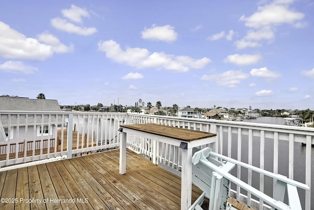 wooden terrace featuring a water view