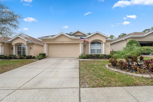 ranch-style home with a front yard and a garage