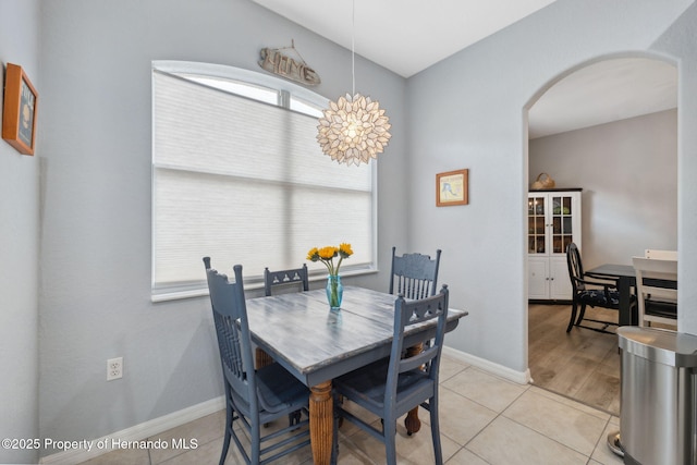 tiled dining area featuring a healthy amount of sunlight