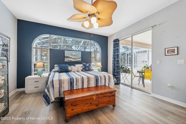 bedroom featuring access to exterior, light wood-type flooring, and ceiling fan