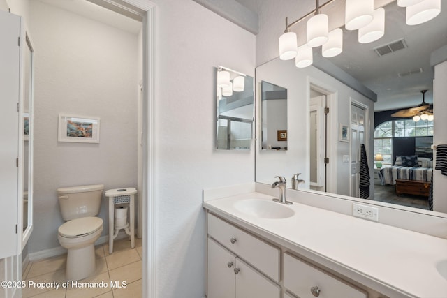 bathroom with toilet, vanity, tile patterned floors, and ceiling fan