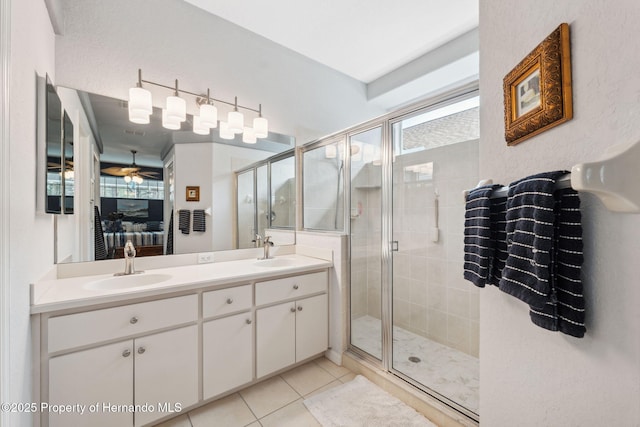 bathroom with ceiling fan, tile patterned flooring, vanity, and a shower with shower door