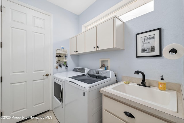 washroom with washer and dryer, cabinets, sink, and light tile patterned floors