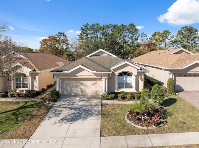 single story home with a garage and a front lawn