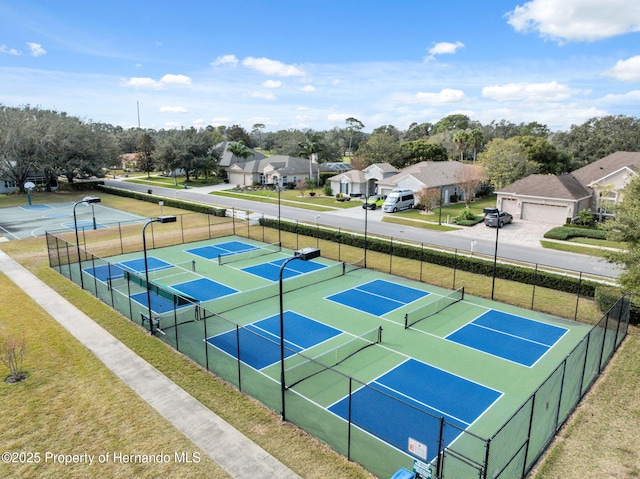 view of tennis court with a lawn and basketball court