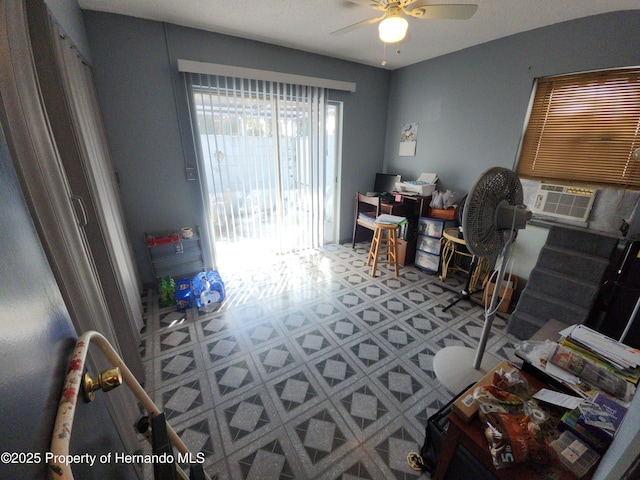 home office with cooling unit and ceiling fan