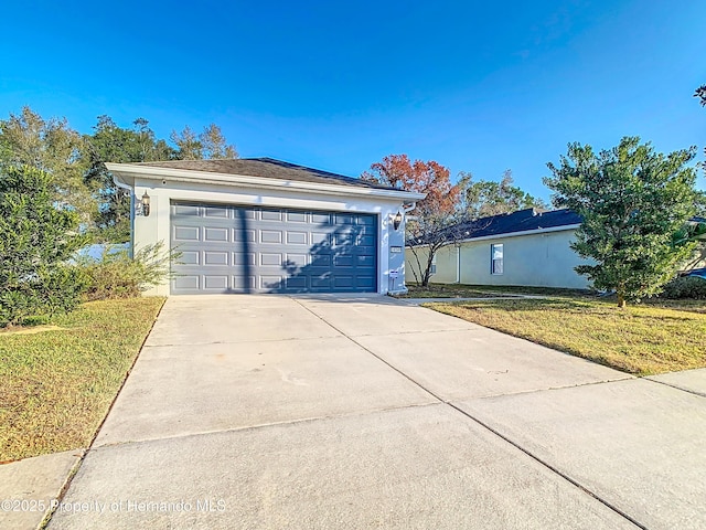 view of front of property featuring a garage and a front lawn