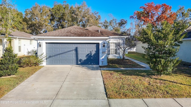 view of front of home featuring a front lawn and a garage