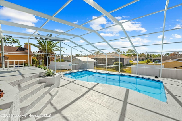 view of swimming pool featuring a lanai and a patio