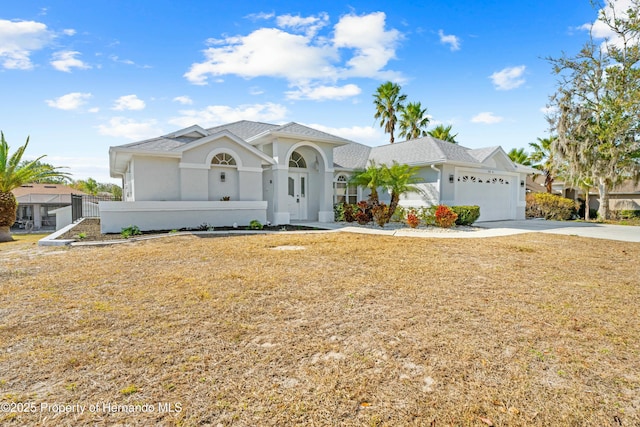 view of front of home featuring a garage and a front lawn