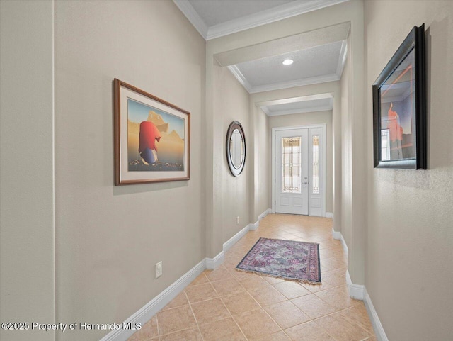 foyer featuring light tile patterned flooring and ornamental molding