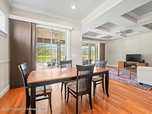 dining room featuring coffered ceiling, ceiling fan, crown molding, and beam ceiling