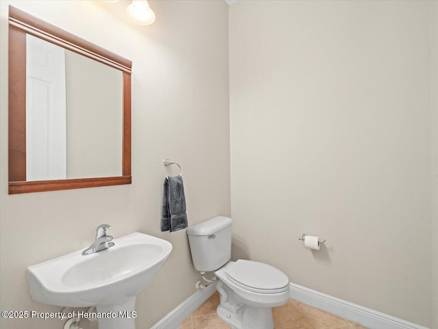 bathroom with sink, toilet, and tile patterned floors