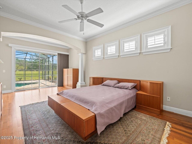 bedroom with access to outside, hardwood / wood-style flooring, a textured ceiling, crown molding, and ceiling fan