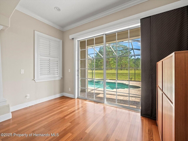 doorway to outside featuring ornamental molding and wood-type flooring