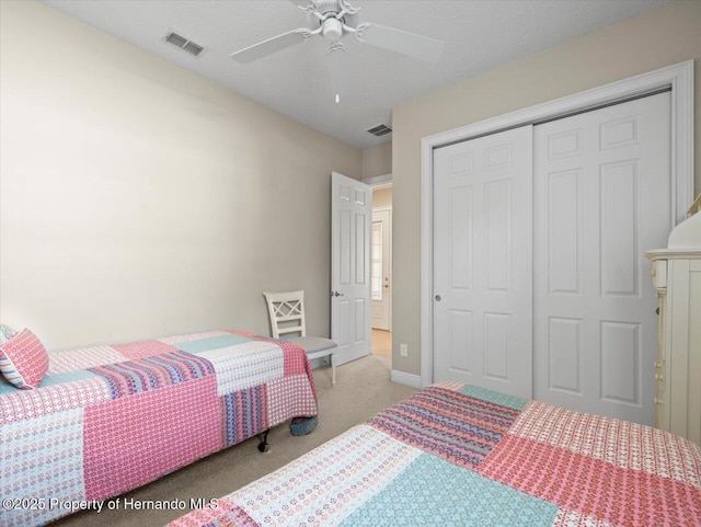 bedroom featuring a closet, ceiling fan, and light colored carpet