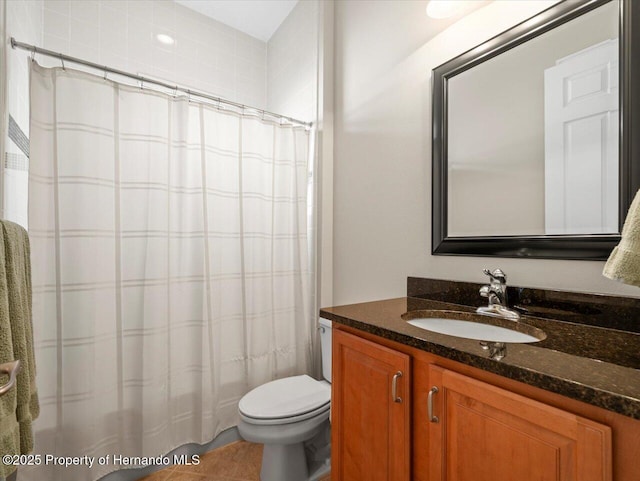 bathroom with curtained shower, tile patterned floors, vanity, and toilet