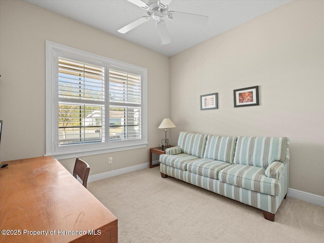 carpeted living room with ceiling fan