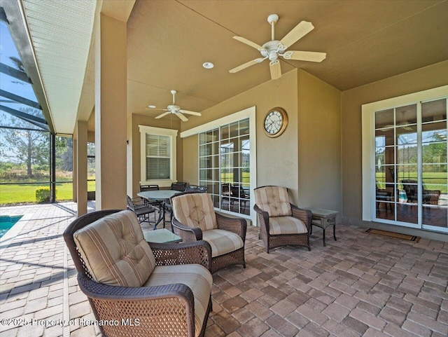 view of patio / terrace with a lanai and ceiling fan